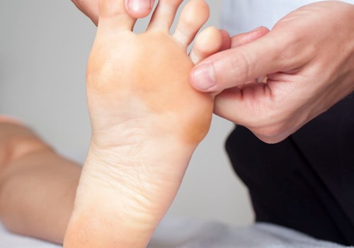 A podiatrist massaging a foot of a patient